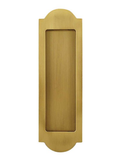 Arched Pocket-Door Flush Pull in Aged Brass.